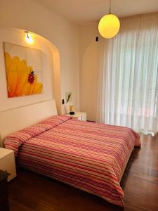 a bedroom with a bed with a red striped blanket at Spazio Prestige in Milan