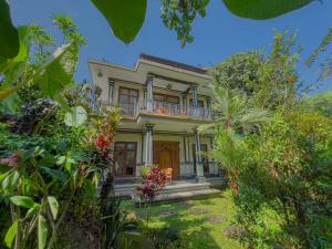 an old house surrounded by trees and plants at Surya Ubud View and Suites by EPS in Ubud