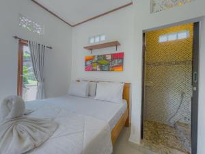 a bedroom with a white bed and a shower at Surya Ubud View and Suites by EPS in Ubud