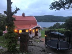 a small house with a car parked in front of it at Amazing Home In Svenshögen With 3 Bedrooms in Svenshögen +6 photos