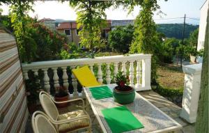 a patio with a table and chairs on a balcony at 1 Bedroom Beautiful Apartment In Vrbnik in Vrbnik