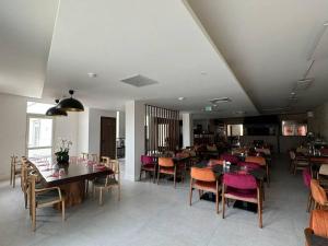 a dining room with tables and chairs in a restaurant at Hôtel Restaurant La Paillote in Cavignac