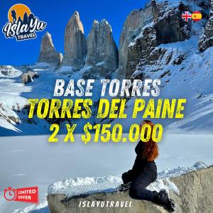 a poster of a woman sitting on a rock in the snow at Cabañas Little Home in Puerto Natales