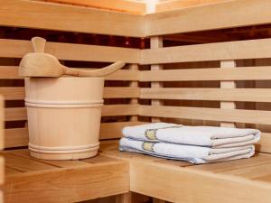 a sauna with a stack of towels on a shelf at La Chiesa Lukas in Obergurgl +29 photos