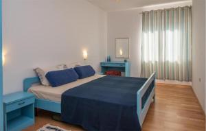 Un dormitorio con una gran cama azul en una habitación. en 2 Bedroom Cozy Apartment In Vrbnik, en Vrbnik