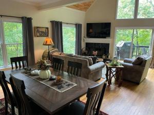 a living room with a table and a couch at Helen, GA Bear Paw Haus 4 bdrm, sleeps 10, fire pit, pool table, on Golf course in Helen
