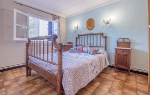 a bedroom with a wooden bed and a window at Awesome Home In Sant Miquel De Fluvià in San Miguel de Fluviá