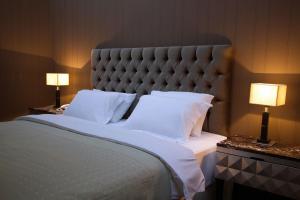 a bedroom with a large bed with two lamps at Vienna Suites in Vienna