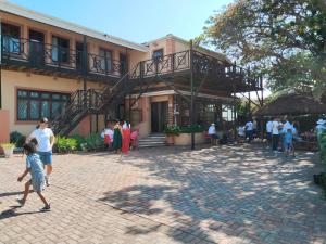 a group of people standing outside of a building at Ikhayalam lodge in Gqeberha