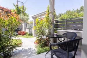 een terras met een tafel en stoelen op een balkon bij Ionas Apartments 1 in Nea Skioni