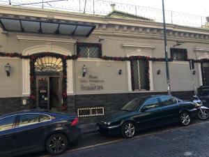 two cars parked in front of a building at Villa Margherita in Naples