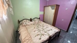 a bedroom with a bed with flowers on it at Villa SAAD in Khenchela
