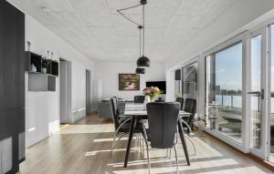 a dining room with a table and chairs at 2 Bedroom Cozy Home In Bjert in Bjert Strand