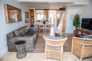 a living room with a couch and a table at WATERFRONT - 26 Spinniker in Knysna