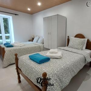 a bedroom with two beds and a cabinet at Quinta Cunha in São Pedro do Sul