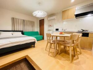 a bedroom with a bed and a table and chairs at Asakusa Hana hostel in Tokyo