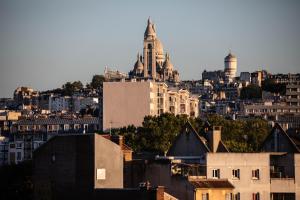 a view of a city with buildings and buildings at Paris Flea Market Comfy Flat in Saint-Ouen