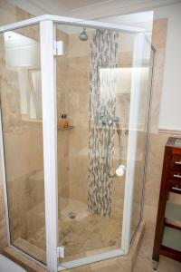 a shower with a glass door in a bathroom at WATERFRONT - 26 Spinniker in Knysna +42 photos