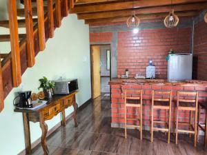 a kitchen with a counter and a brick wall at Pousada Recanto Sobradinho in Bonito
