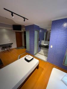 a living room with a white couch and a blue wall at Hotel Estrela da Agua Fria in Sao Paulo +66 photos