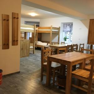 a room with two bunk beds and a table and chairs at Hotel SINOS in Klagenfurt