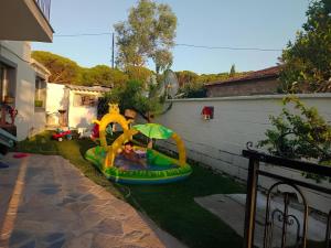 a backyard with a inflatable play set on the grass at Ayvalık Milda Konuk Evi in Ayvalık