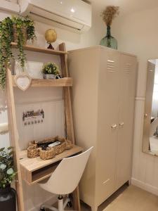 a room with a desk and a white chair at "COZY LOFT", TERRACE, PARKING and SWIMMING POOL in Málaga