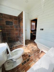 a bathroom with a toilet and a bath tub at Belton Bed and Breakfast in Belton