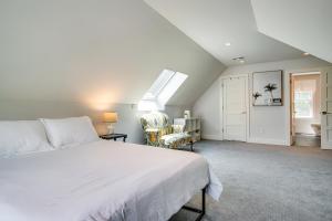 a bedroom with a bed and a chair and a window at Furnished Patio Family-Friendly Cape Cod Home! in Centerville