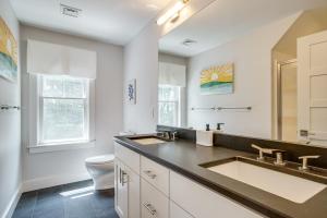 a bathroom with two sinks and a toilet at Furnished Patio Family-Friendly Cape Cod Home! in Centerville