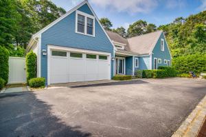 a blue house with a white garage at Furnished Patio Family-Friendly Cape Cod Home! in Centerville