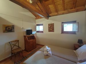 a bedroom with a bed and a desk and a chair at Posada de Serrada in Serrada de la Fuente