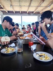 a group of people sitting at a table eating food at Gran Hotel Virrey in San Ramón