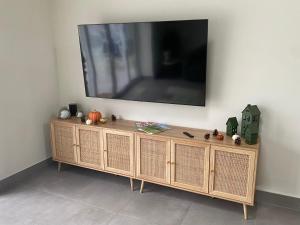 a flat screen tv on top of a wooden cabinet at Luxurious and Peaceful Lakeside House, Clitheroe in Clitheroe