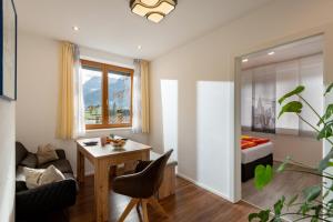a living room with a desk and a bed at Ferienwohnung Weiss in Waidring