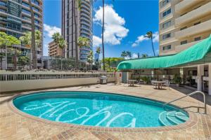a swimming pool in the middle of a building at Spacious 2 Bedroom, 1 bath Waikiki Condo in Honolulu