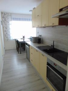 a kitchen with a sink and a stove top oven at Apartmán u Jána in Ružomberok