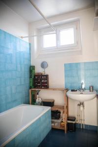 a bathroom with a tub and a sink at Paris Flea Market Comfy Flat in Saint-Ouen