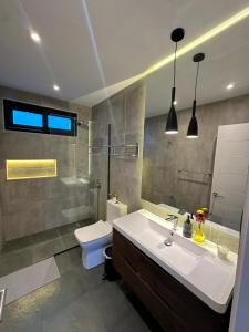 a bathroom with a sink and a toilet at Seaside House Pichilemu in Pichilemu +27 photos