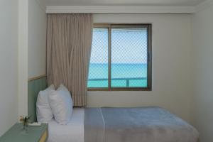 En eller flere senge i et værelse på Apartamento Beira Mar Boa Viagem + 23 billeder