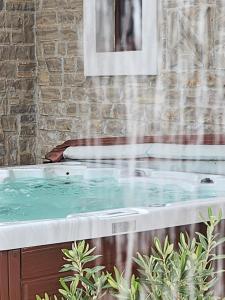 a hot tub with water shooting out of it at Villa Melody Novalja in Novalja
