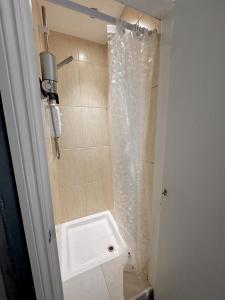 a bathroom with a sink and a shower curtain at London Collection - Bayswater in London