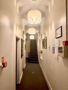a hallway with a stairway with a hallwayngthngthngthngthngthngthngth at London Collection - Bayswater in London