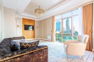 a living room with a couch and a chair at Dreamy Luxury Apartment in Tashkent