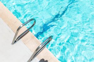 a swimming pool with a pair of tongs in the water at 1BR with Stunning Ocean Views, Near Beach & Parking in Honolulu