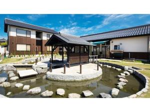 a pond in front of a building with a gazebo at Racine Home Harie - Vacation STAY 06972v in Takashima
