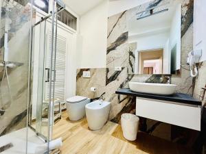 フォルリにあるSMART SUITES FORLI'の洗面台とガラスのシャワーを備えたバスルーム +30枚の写真