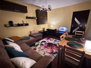 a living room with a couch and a table at Fortress View Apartment in Timişoara