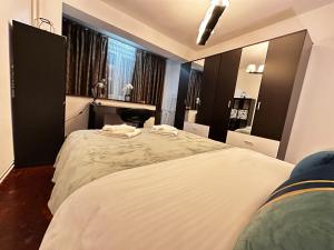 a bedroom with two beds and a sink and a mirror at Fortress View Apartment in Timişoara