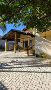 a house with a pavilion in front of it at amplo sobrado perto da praia in Florianópolis